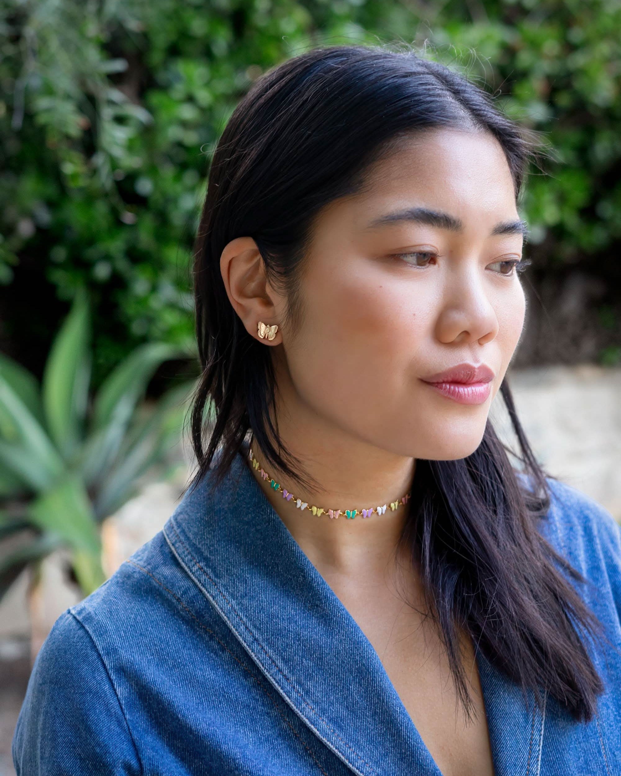 Woman wearing medium sized gold butterfly earring