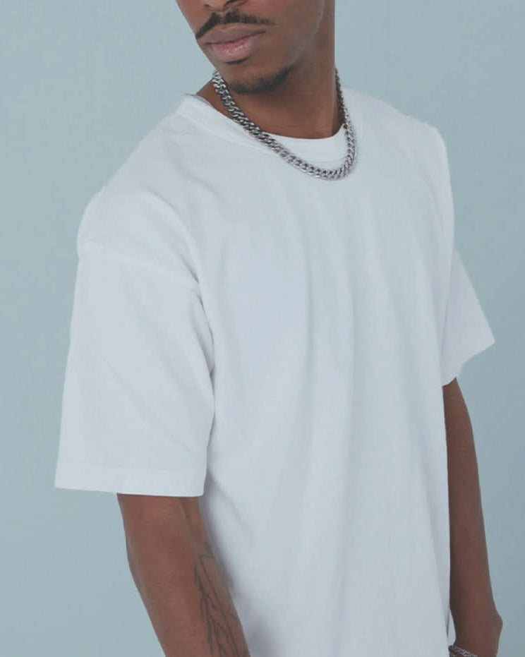 Man wearing white vintage, washed, oversized, box, tee t-shirt on white background
