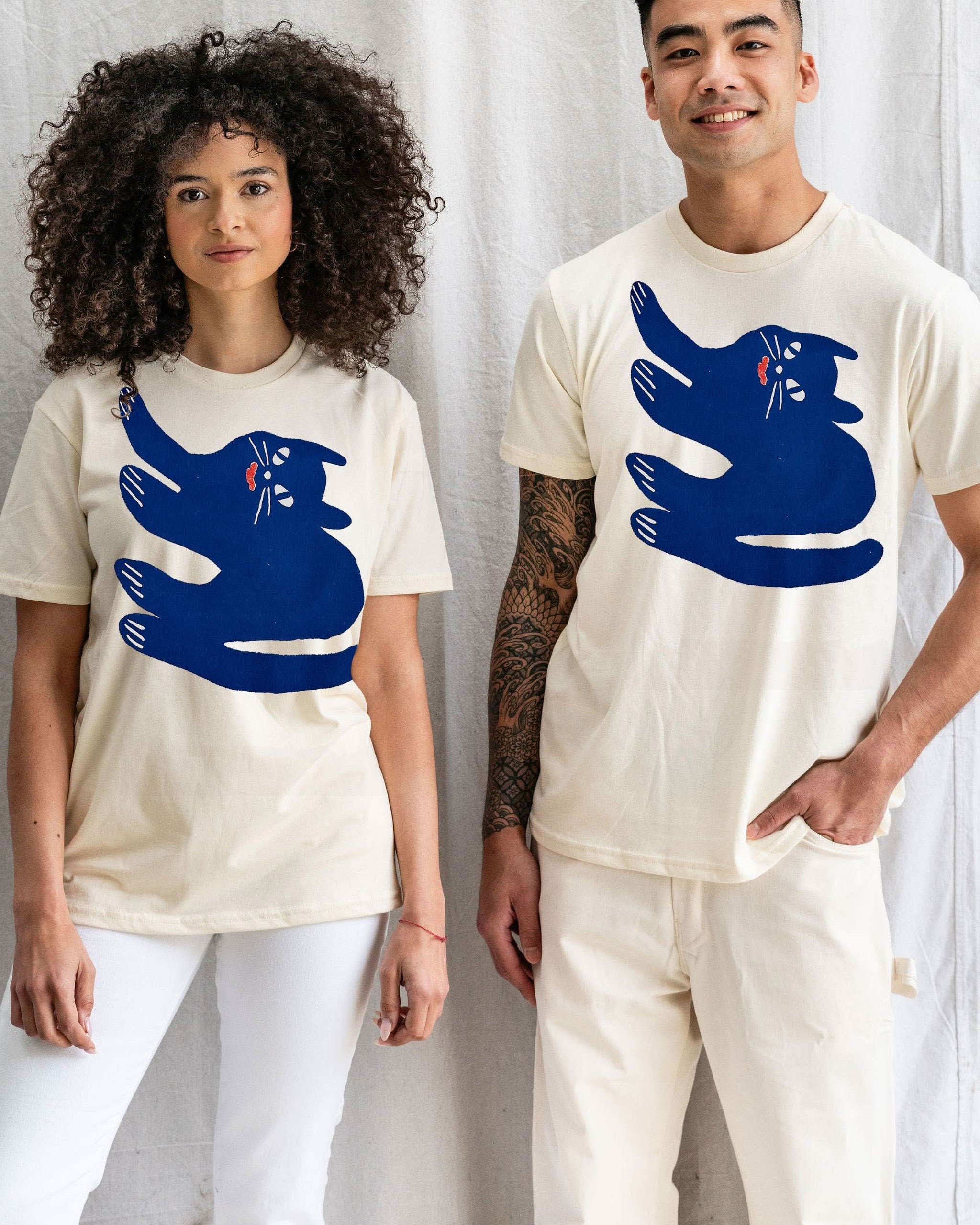 Woman and man model both wearing Cream white Tshirt tee with blue sideways smiling cat doodle