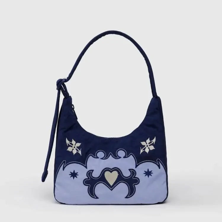 Navy blue handbag with decorative western elements on a light gray background