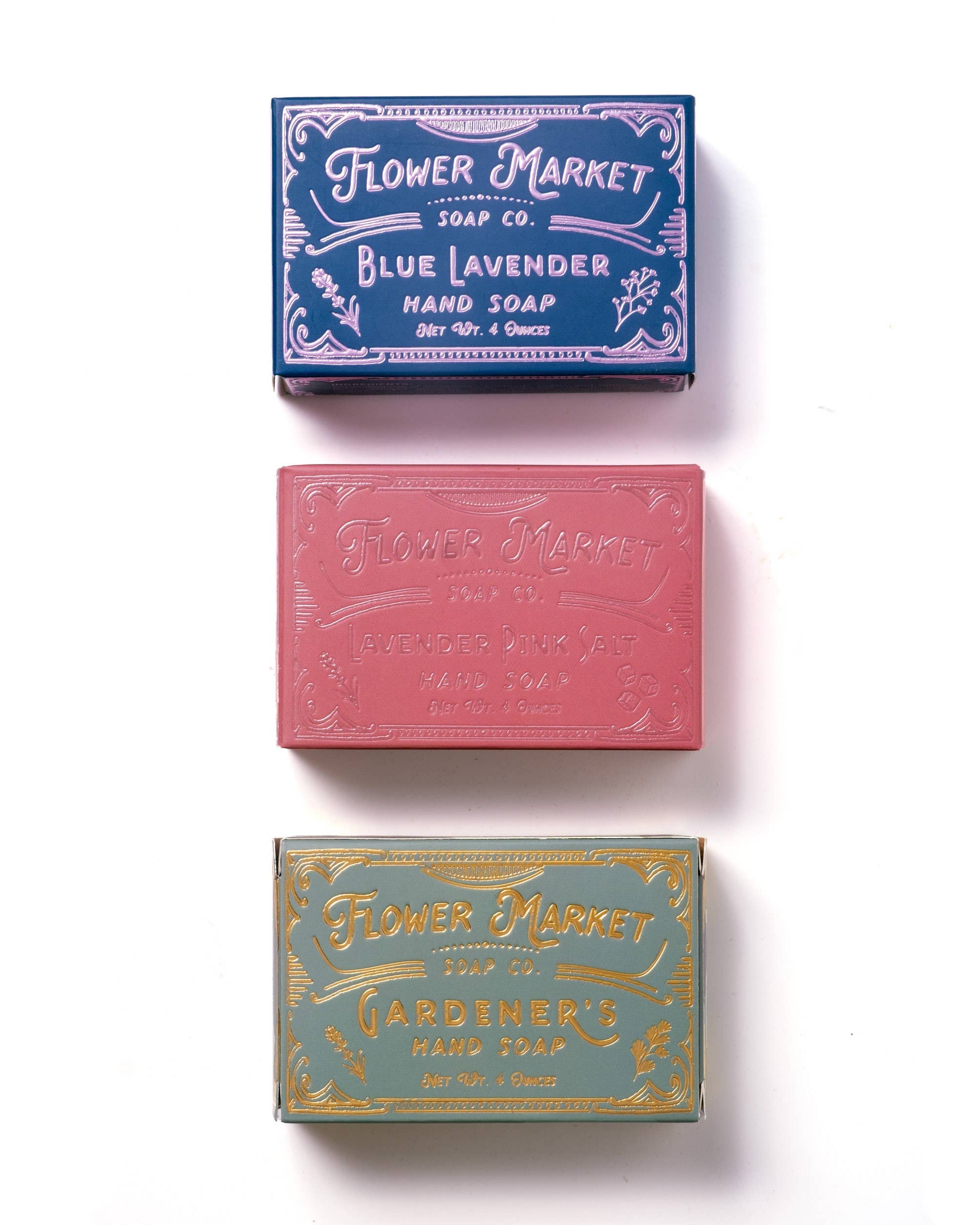 Three bars of soap with decorative packaging on a white background