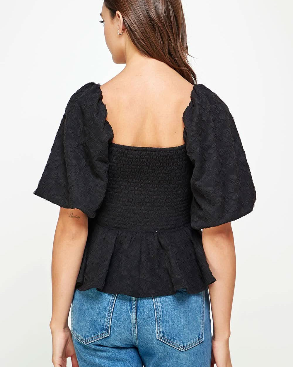 Back view Woman wearing Ballon puffy sleeve ruffle black top