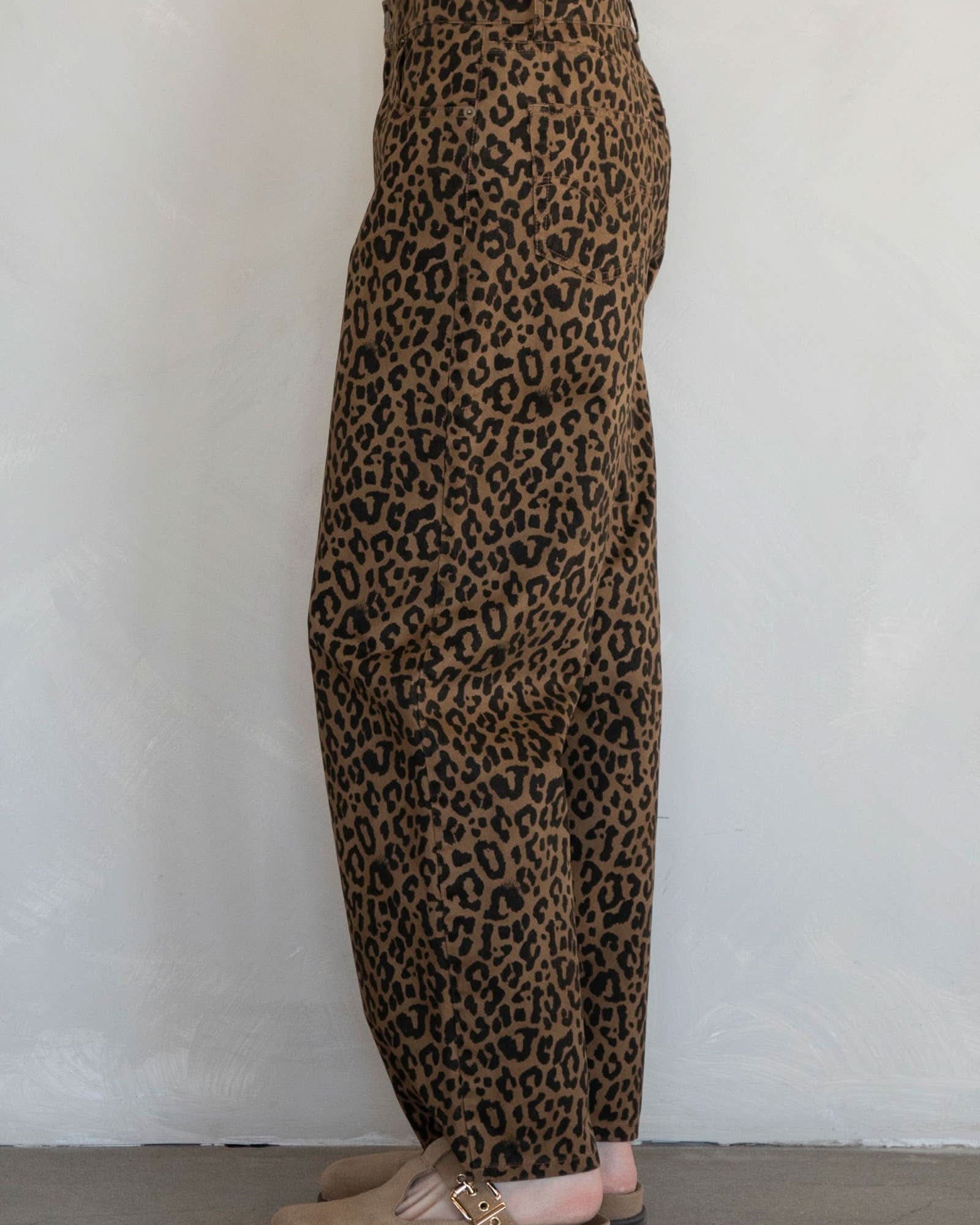 Leopard print pants worn by a person on a plain background
