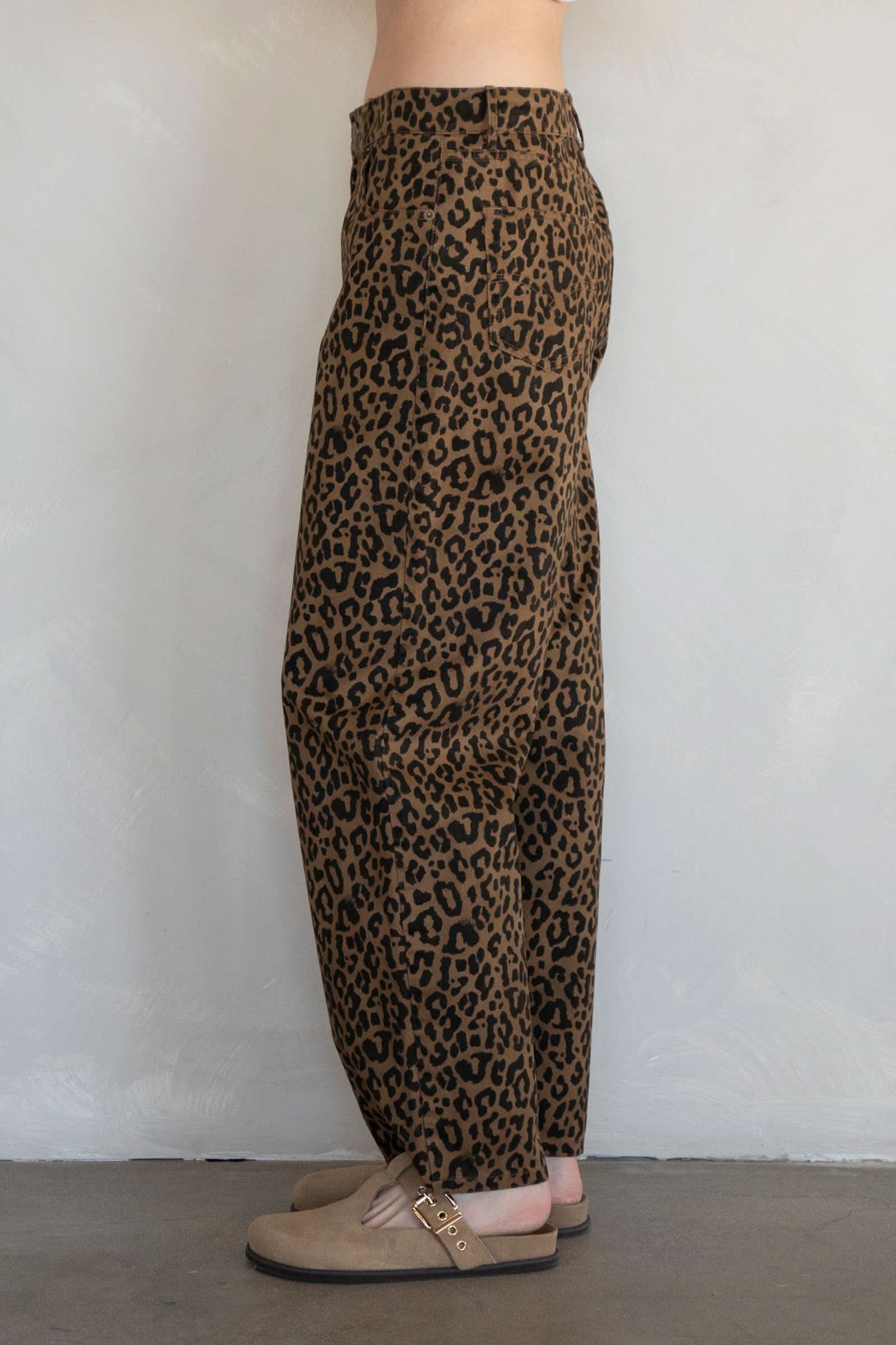Leopard print pants worn by a person on a plain background