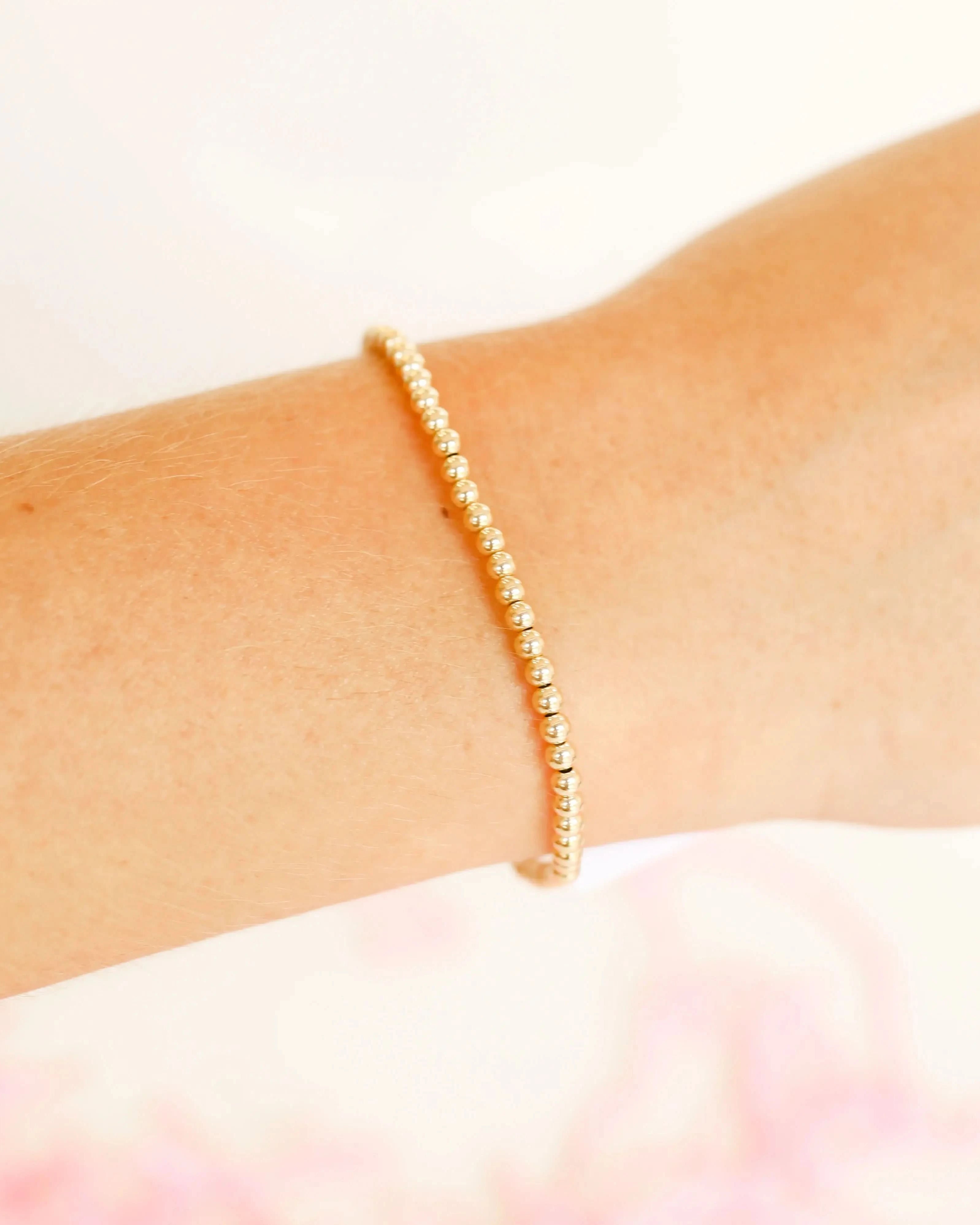 14K Gold Filled Beaded Bracelet Gold bracelet on a wrist with a soft pink