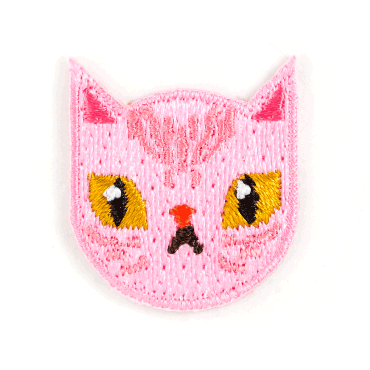 Pink knitted cat face with yellow eyes and red nose on a white background