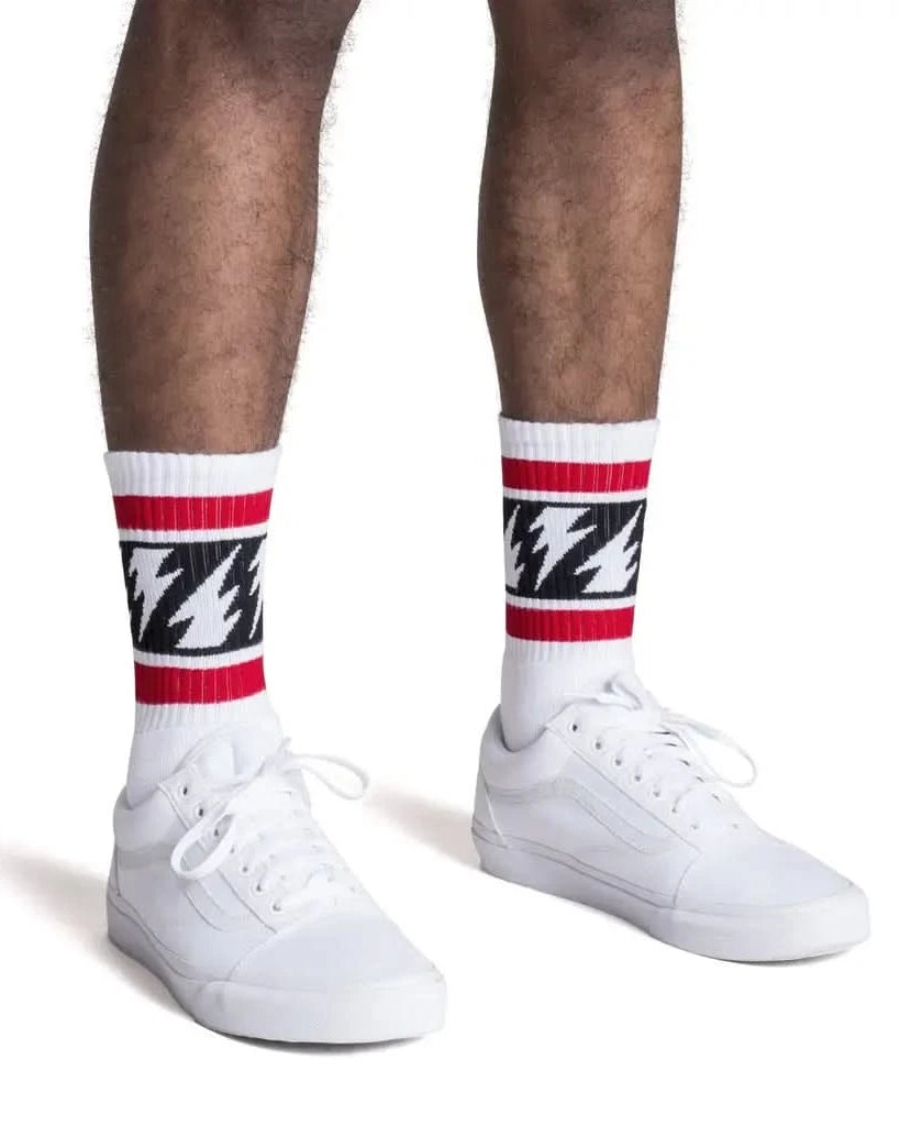 Man wearing White tube socks with red stripe on top, black stripe with white lighting bolts in middle and red stripe on bottom
