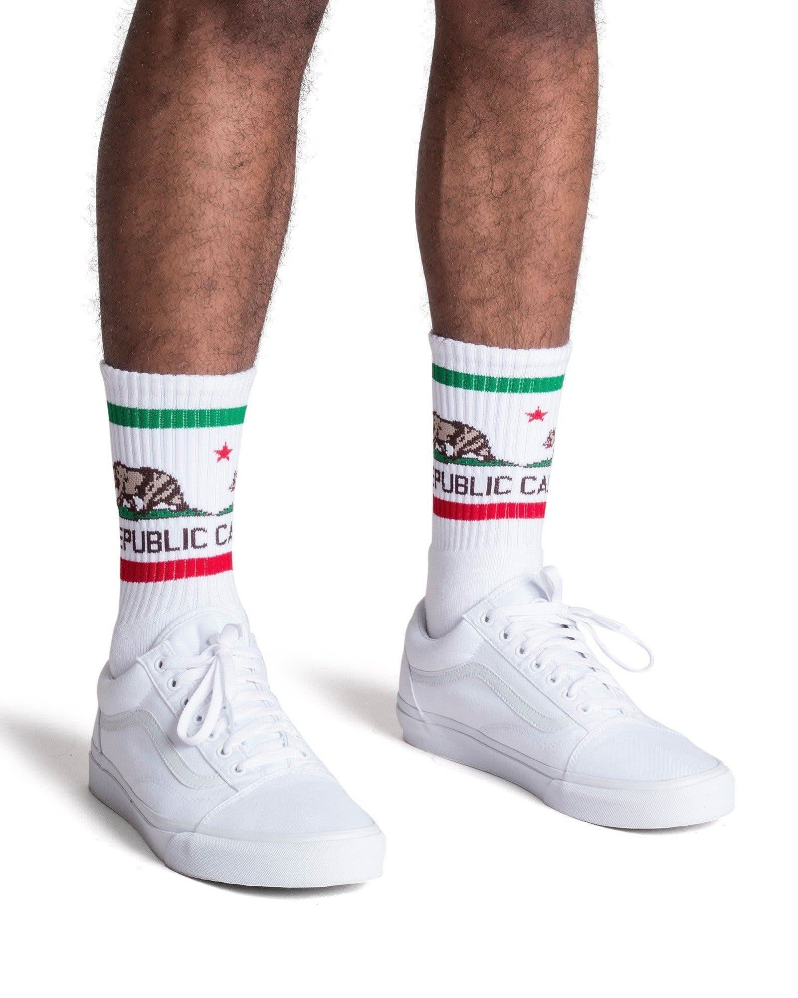 Man wearing California Republic tube socks with stripes and white shoes