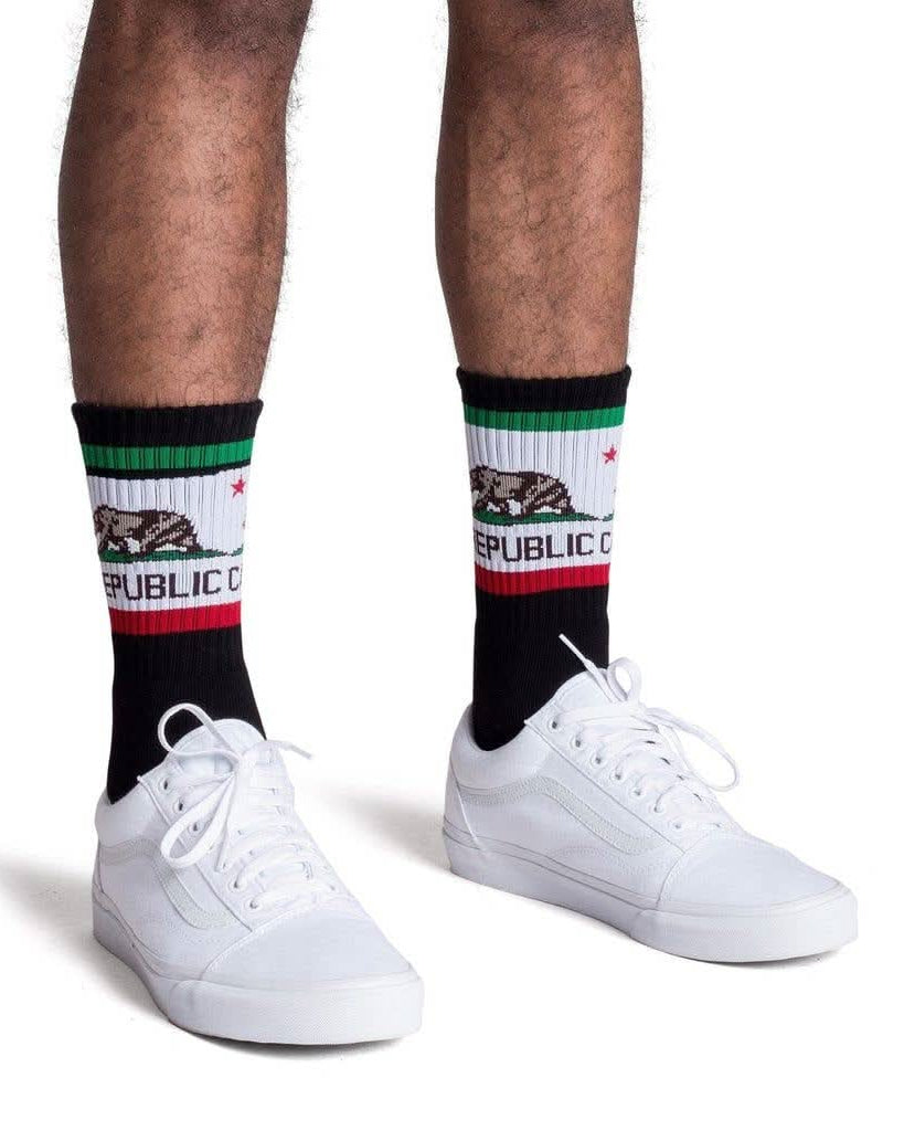 Man wearing black tube socks with California Republic flag and bear print
