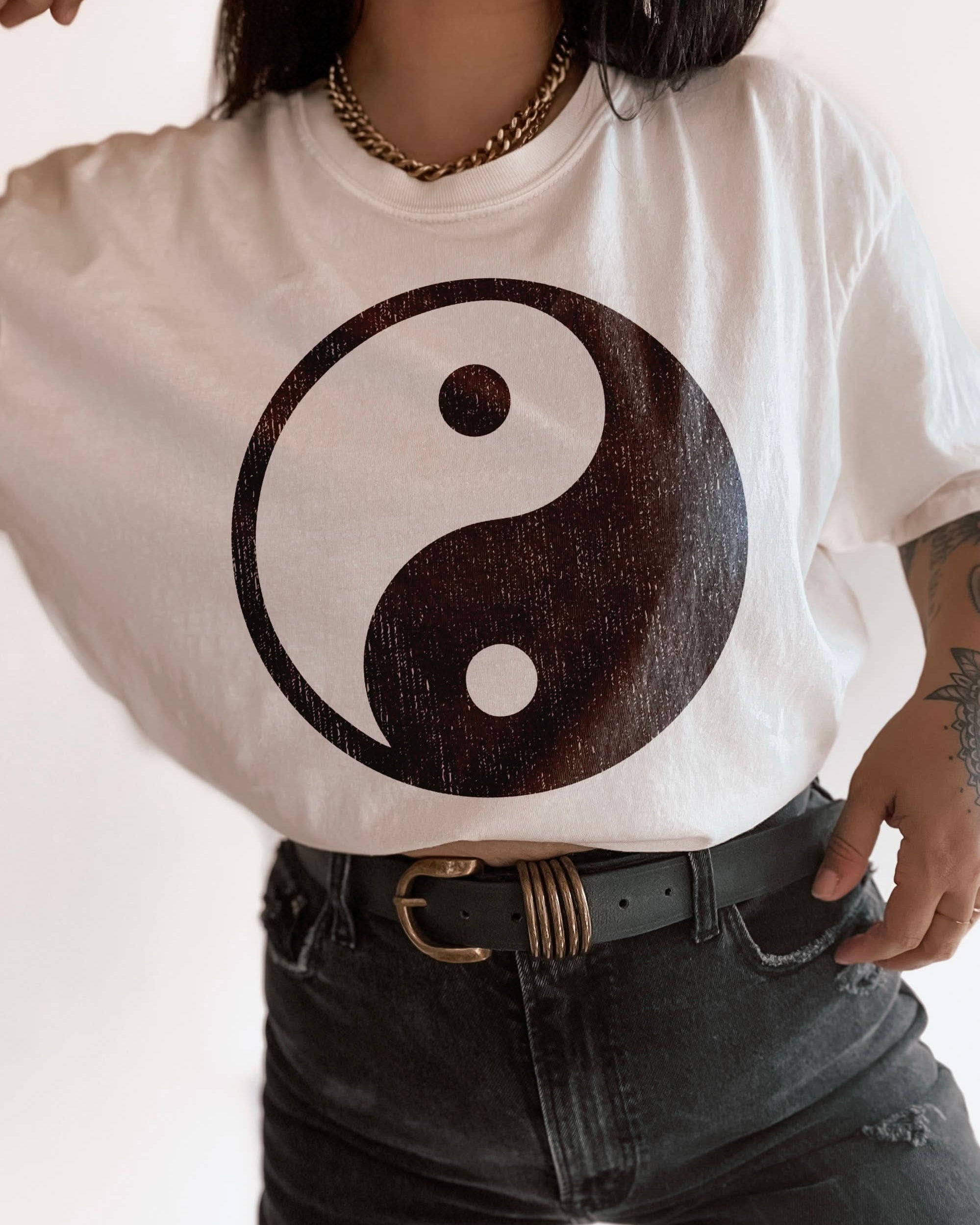woman wearing hand printed, tucked t-shirt with distressed Yin-yang boho design