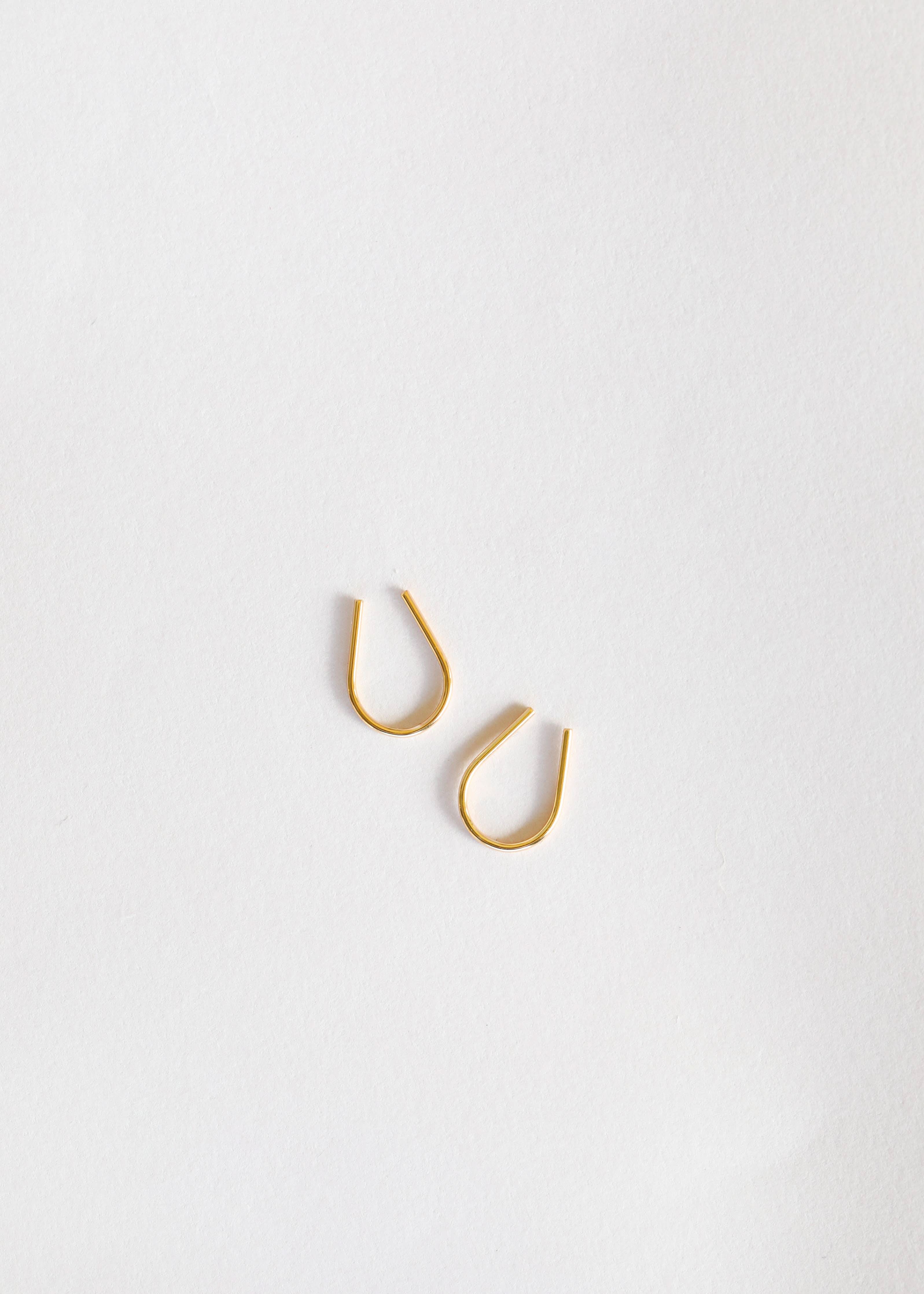 Simple thin gold horseshoe earrings from Jax kelly