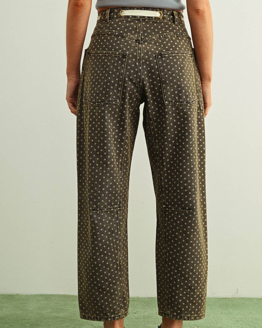Person wearing patterned pants on a plain background