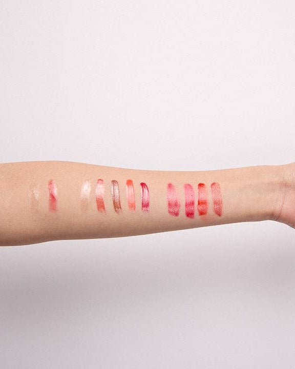 Lipstick swatches on a person's arm against a plain background