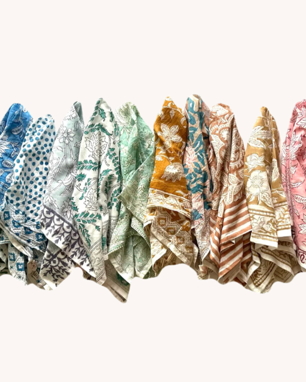 Row of patterned scarves in various colors on a white background