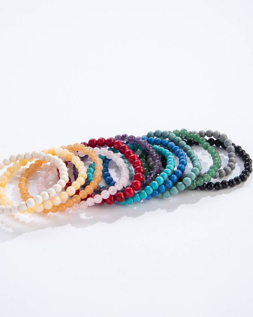 Set of colorful beaded bracelets on a white background