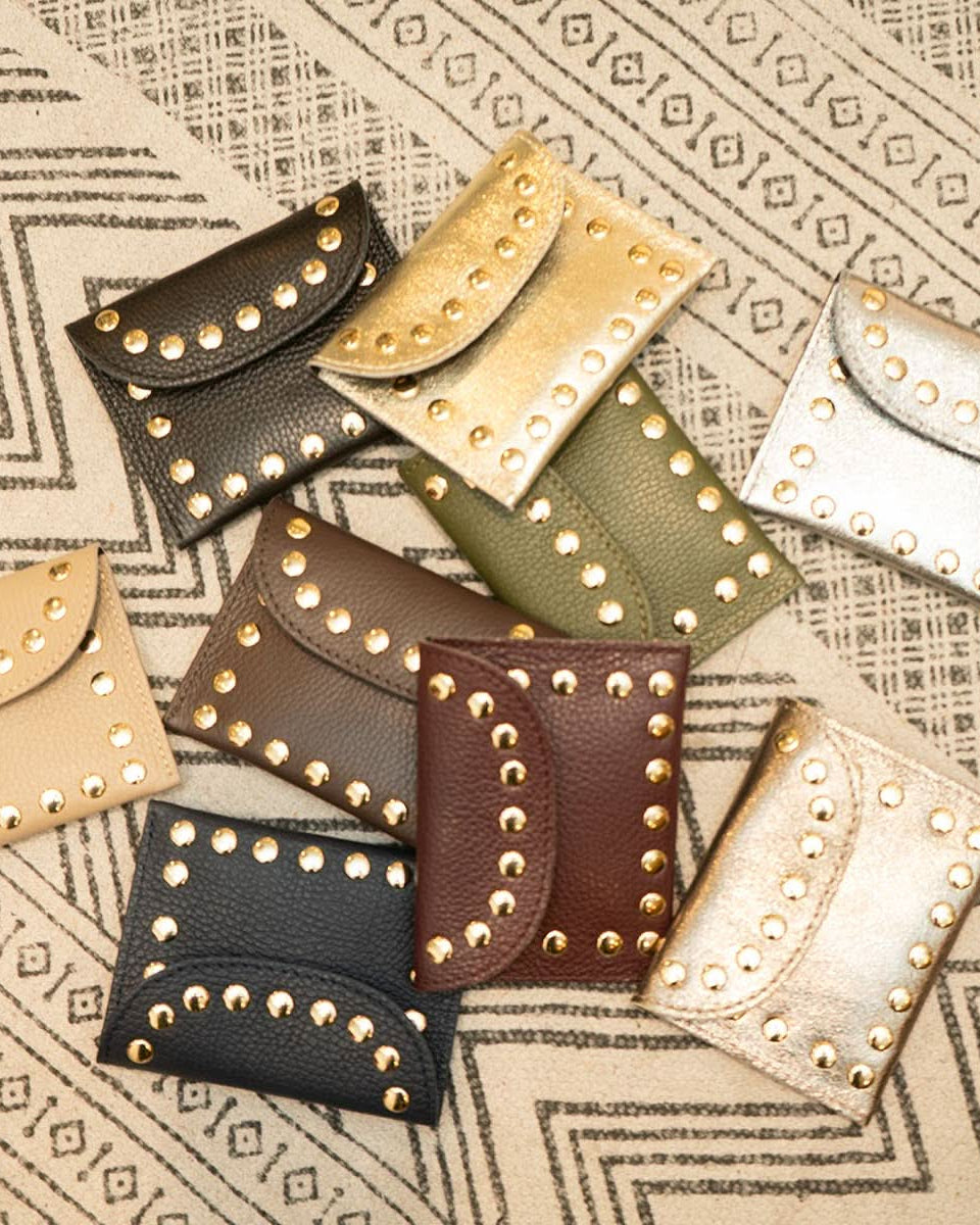 10 assorted colored flap wallet with gold embellishes outlining each wallet