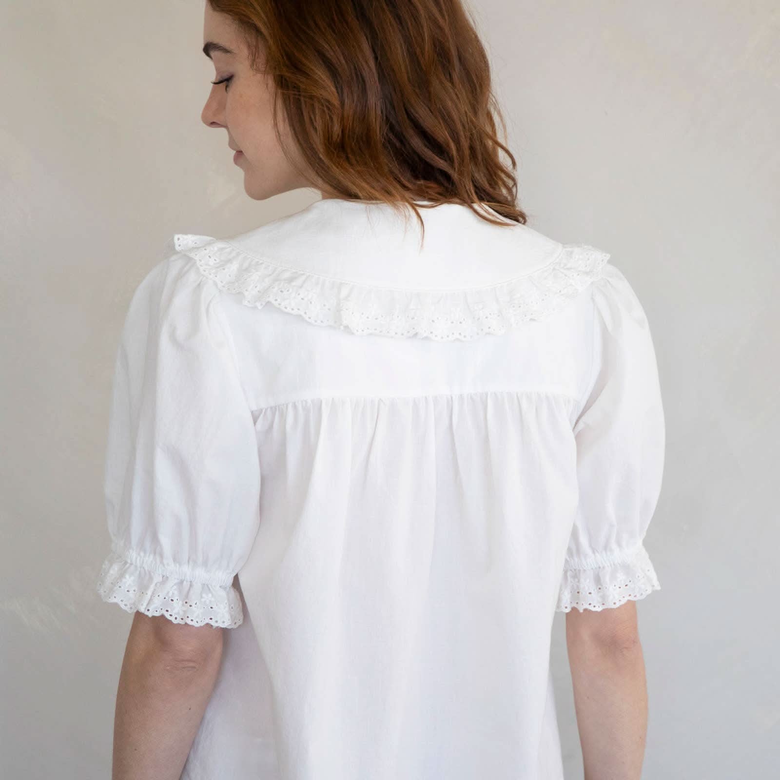 Woman wearing white embroidered collared and half button dreamy sweetheart blouse