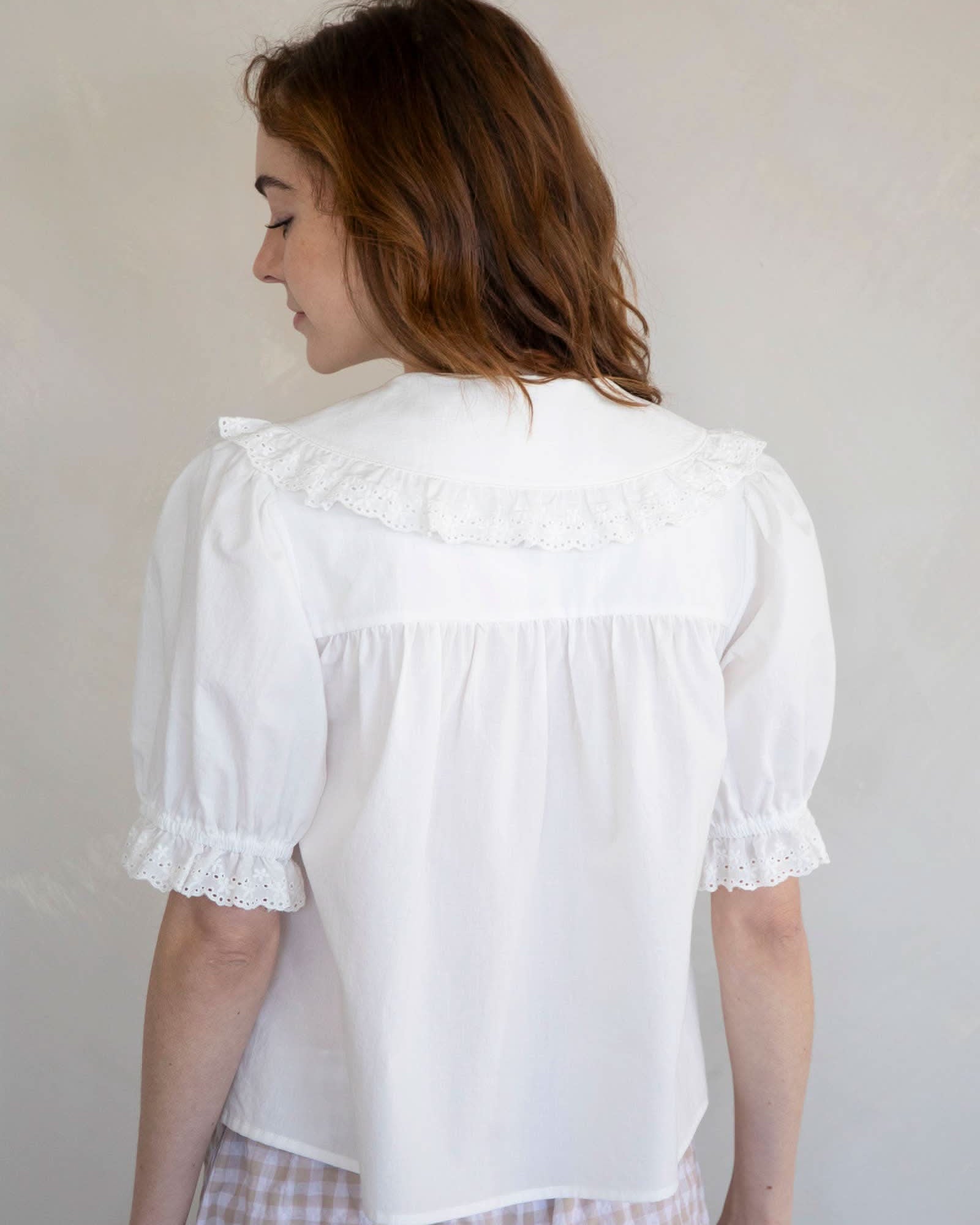 Woman wearing white embroidered collared and half button dreamy sweetheart blouse