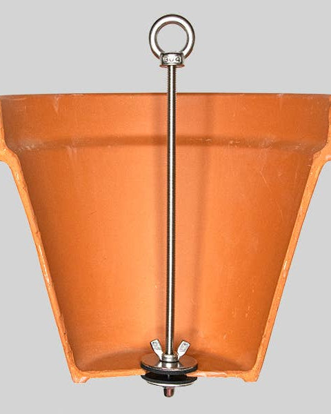 Terracotta hanging planter with a metal hook on a gray background