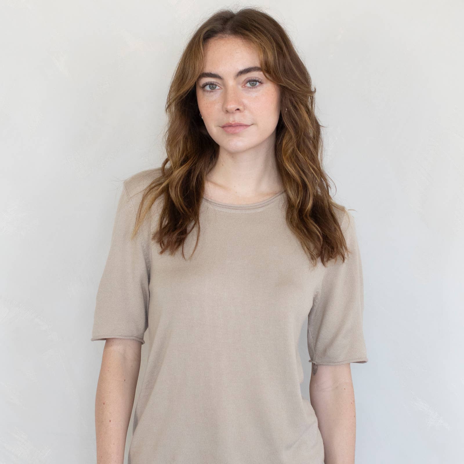 model wearing tan t-shirt sweater