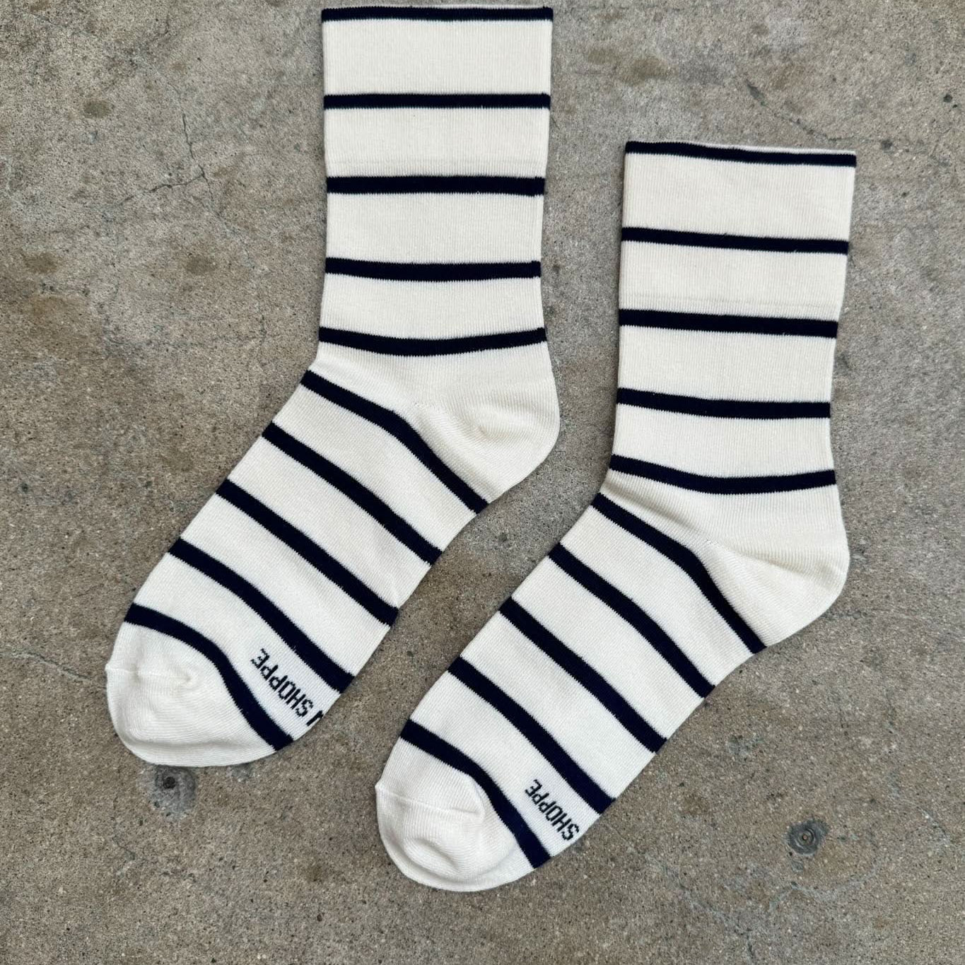 Pair of striped socks on a concrete floor