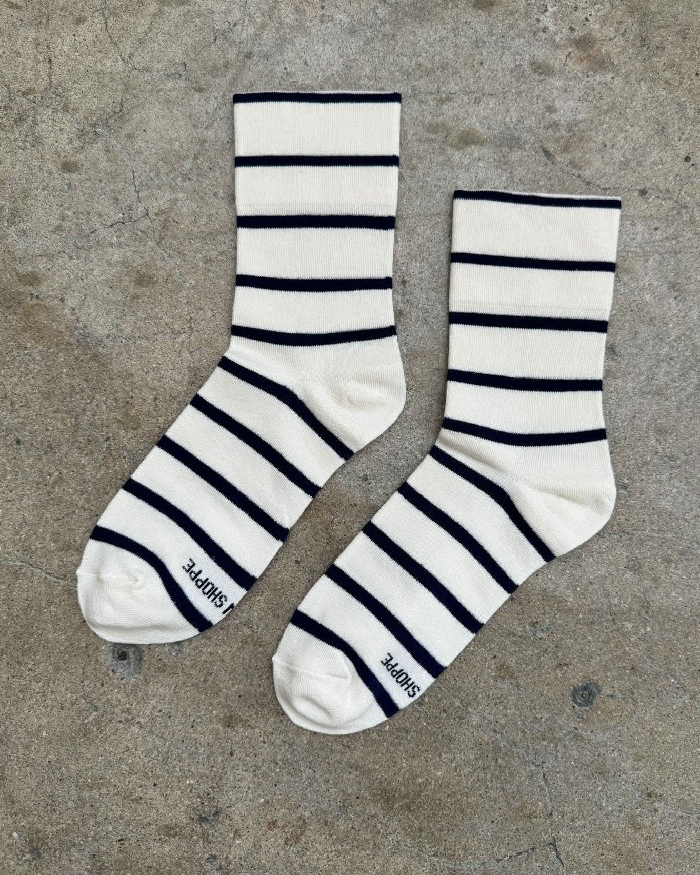 Pair of striped socks on a concrete floor