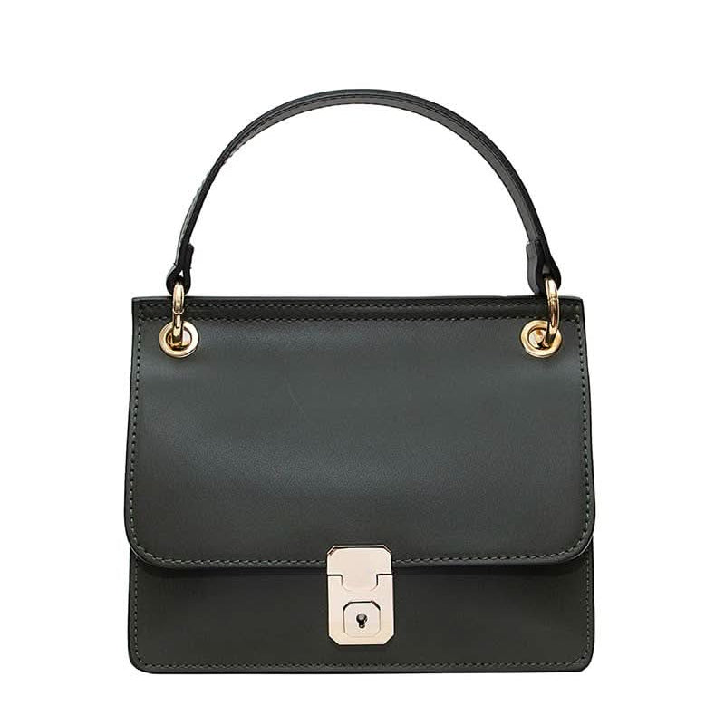 Black leather handbag with gold details and clasp sitting against white background