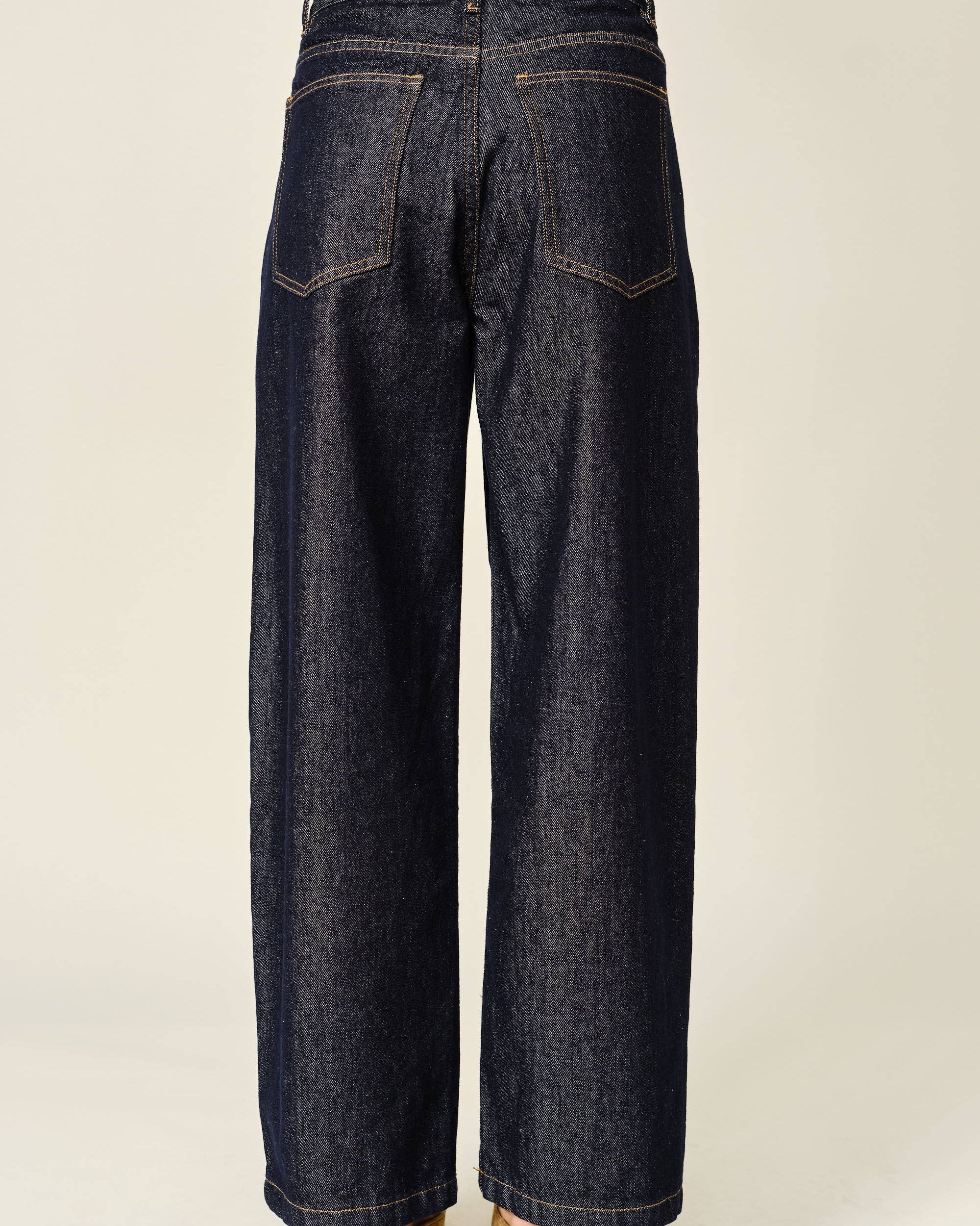 Dark blue wide-leg jeans on a plain background