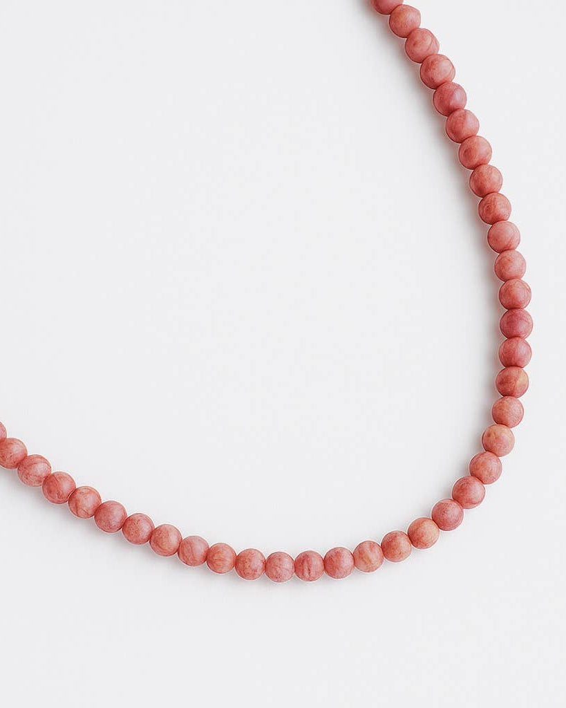 Necklace with pink beads on a white background