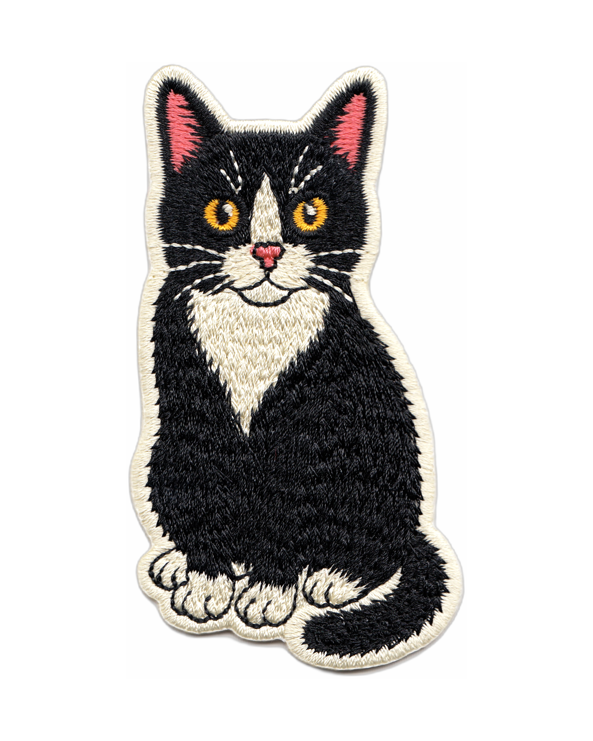 Embroidered patch of a black and white cat on a white background