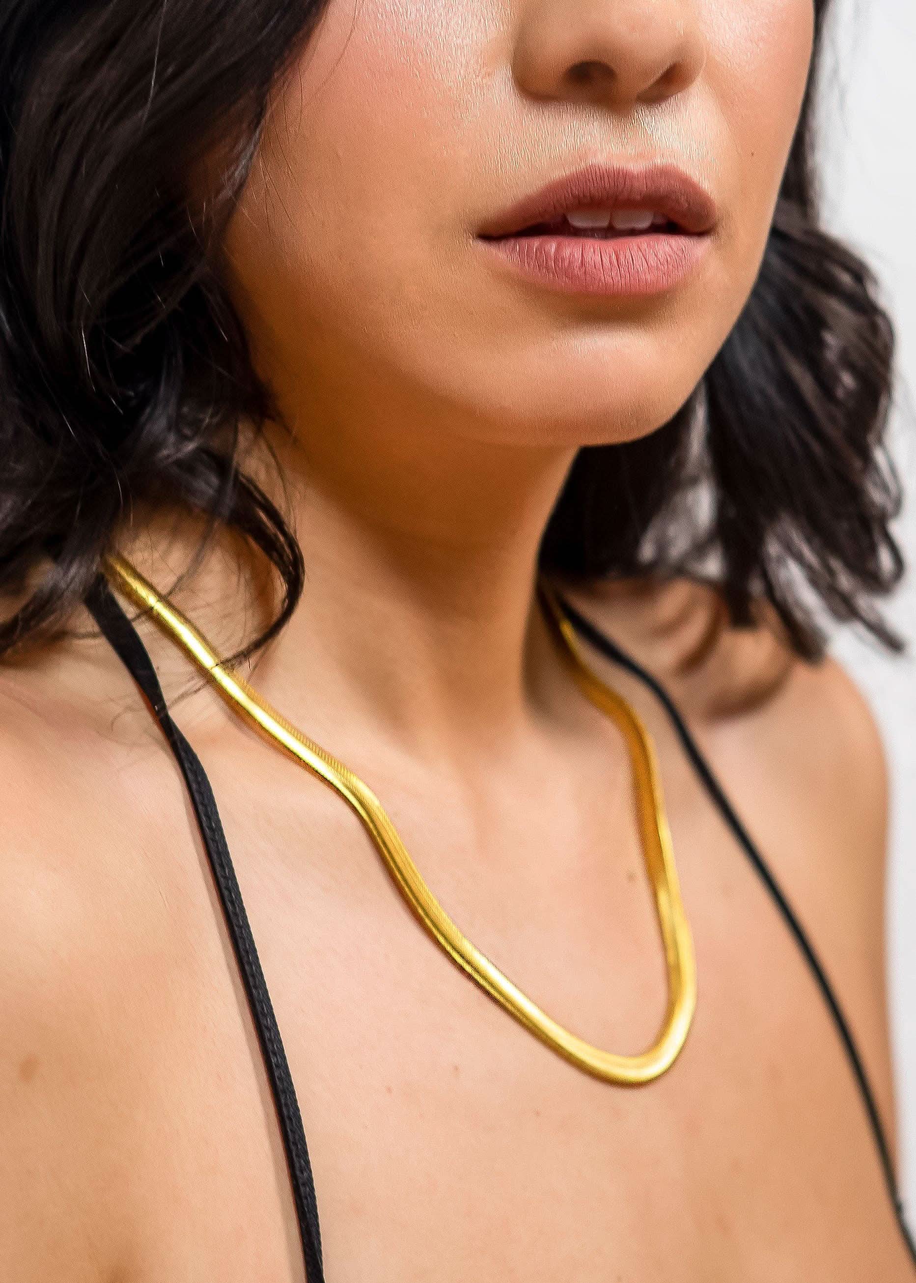 Woman wearing 18k gold 15inch to 17 inch herringbone necklace