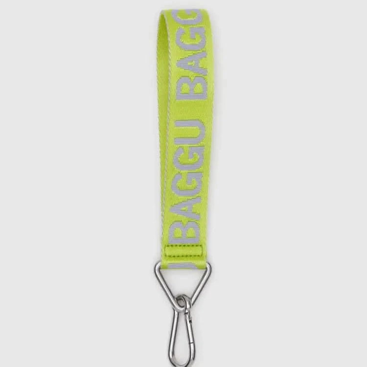 Yellow baggu strap with metal clip on a white background