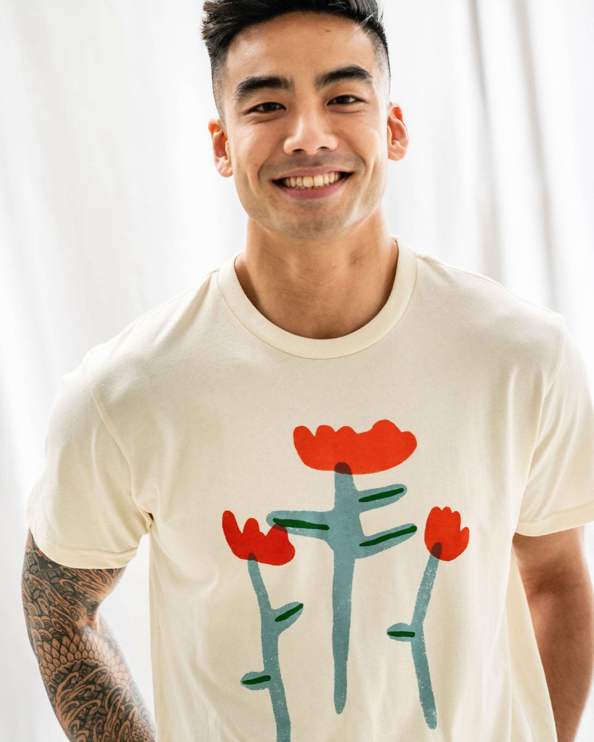 Man smiling wearing Cream white Tshirt tee with three red tulip doodles on the Tshirt