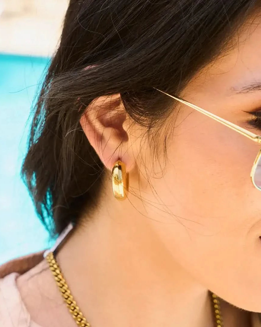 Woman wearing Chunky thick tube hoop earrings