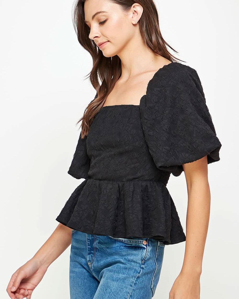 Woman wearing Ballon puffy sleeve ruffle black top