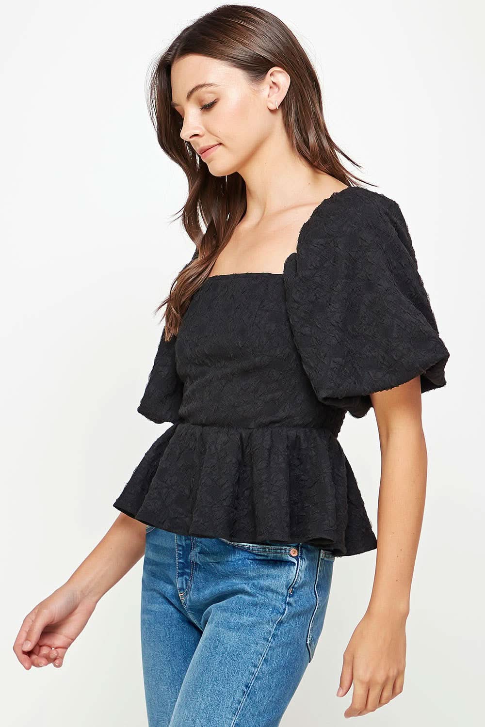 Woman wearing Ballon puffy sleeve ruffle black top