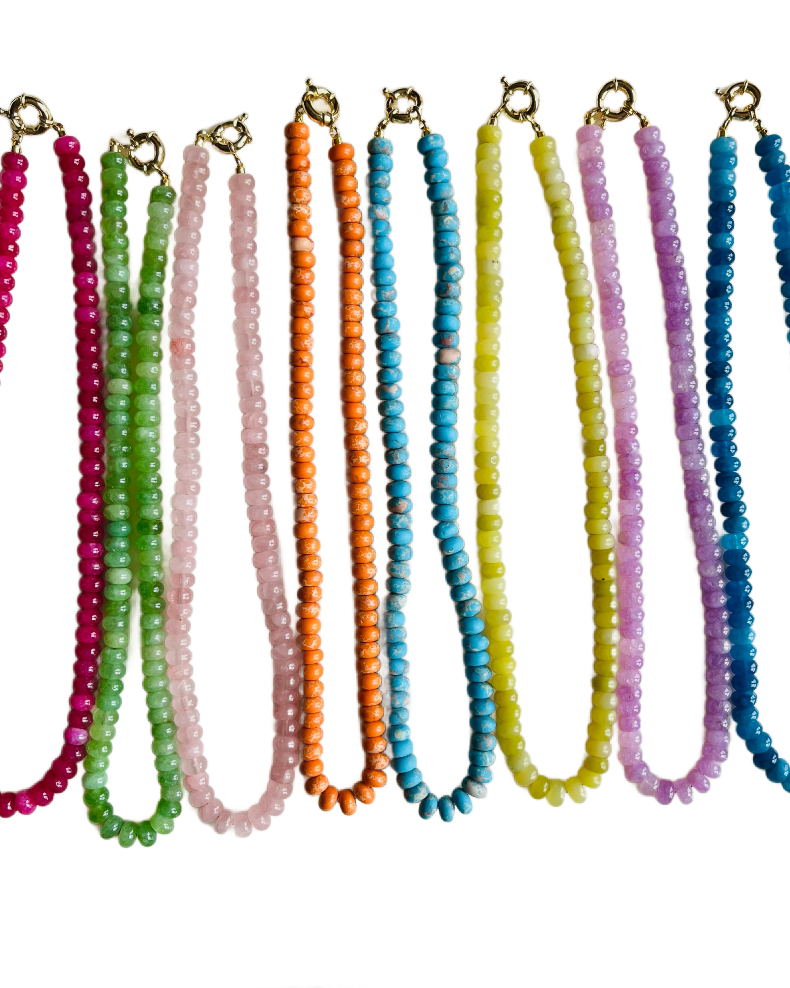 Set of colorful beaded necklaces on a white background