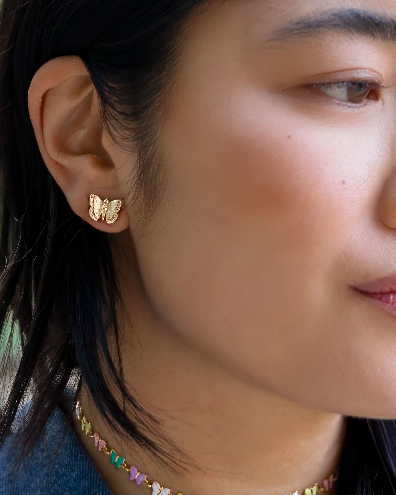 Woman wearing Gold butterfly earring