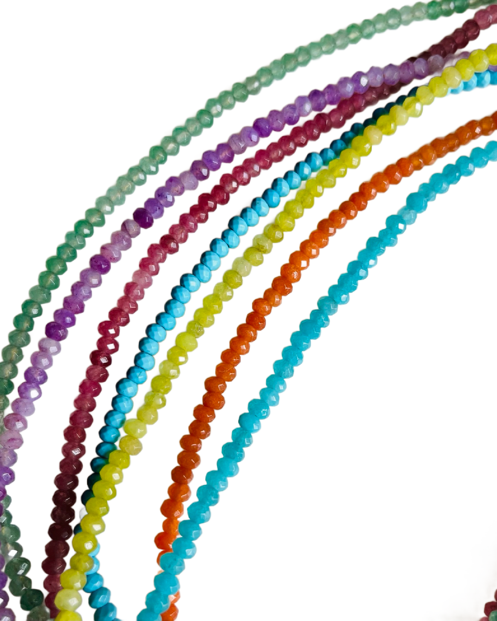 Set of colorful beaded strands on a white background