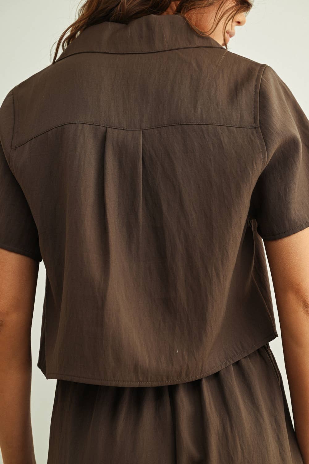 Brown dress with short sleeves on a plain background