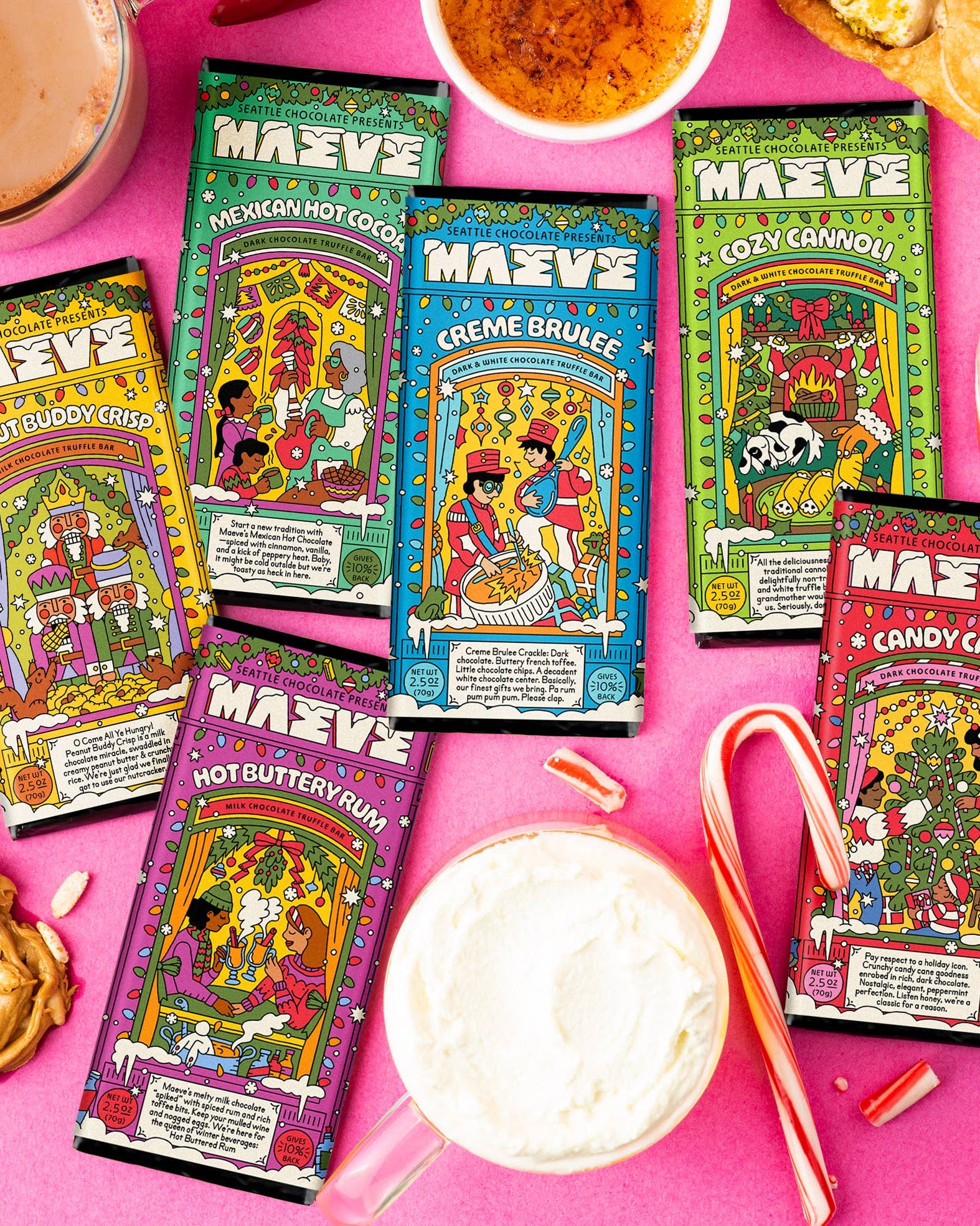 Colorful packages of MAVEE hot chocolate on a pink background with candy canes and cookies.