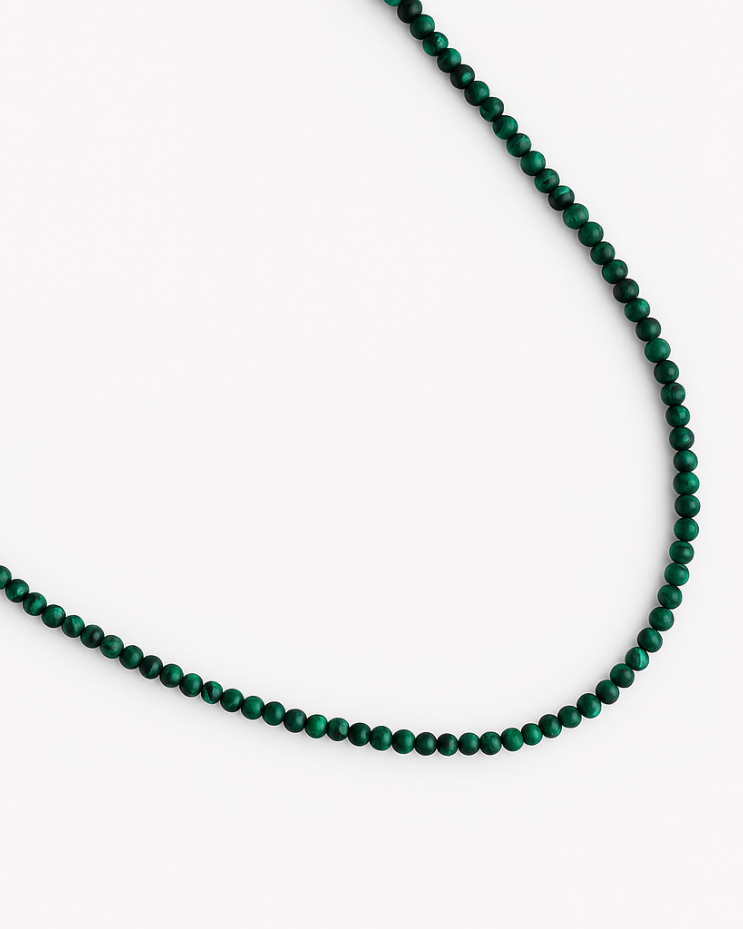 Green beaded necklace on a white background