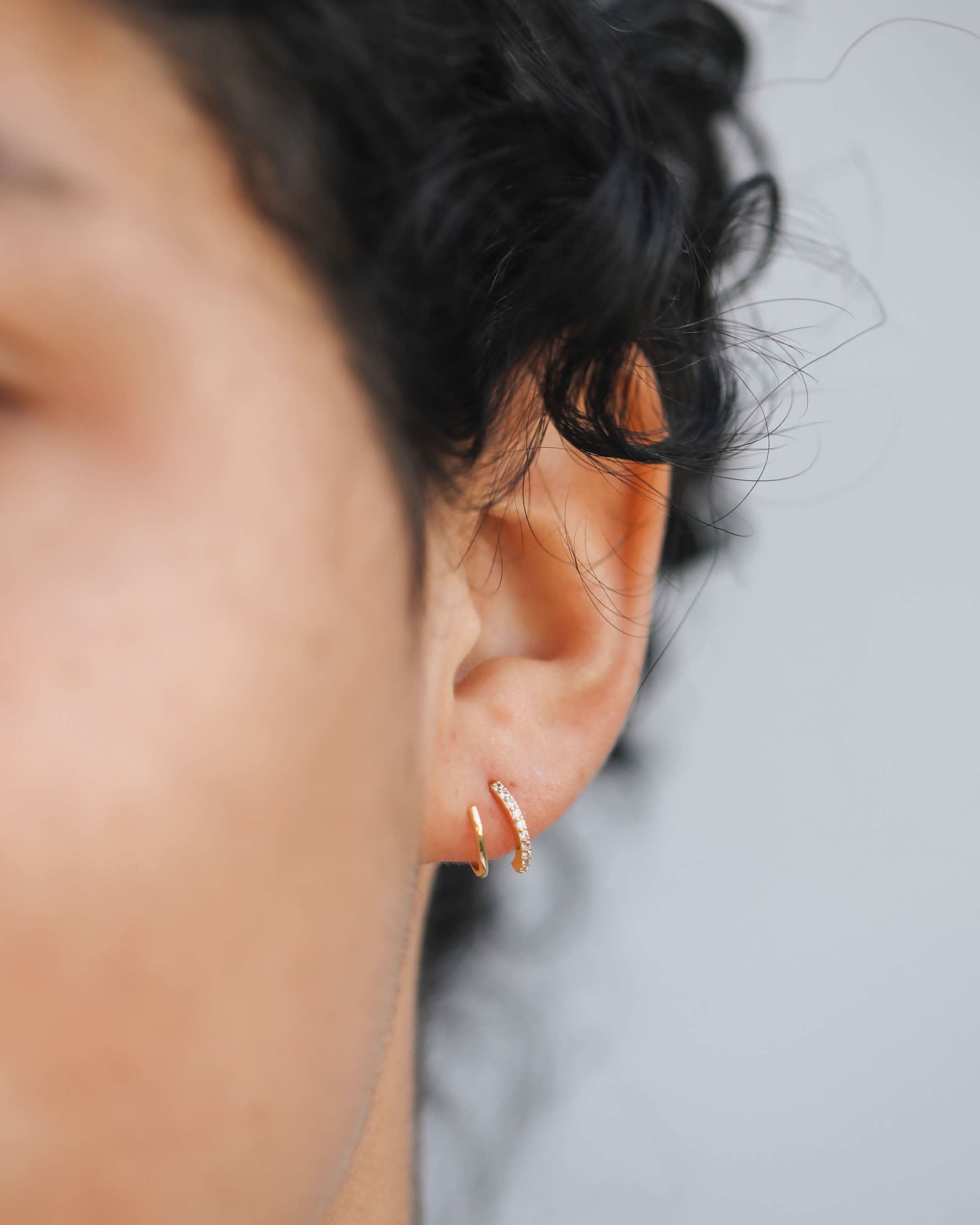 Woman wearing Gold pave spiral earrings from Jaxkelly
