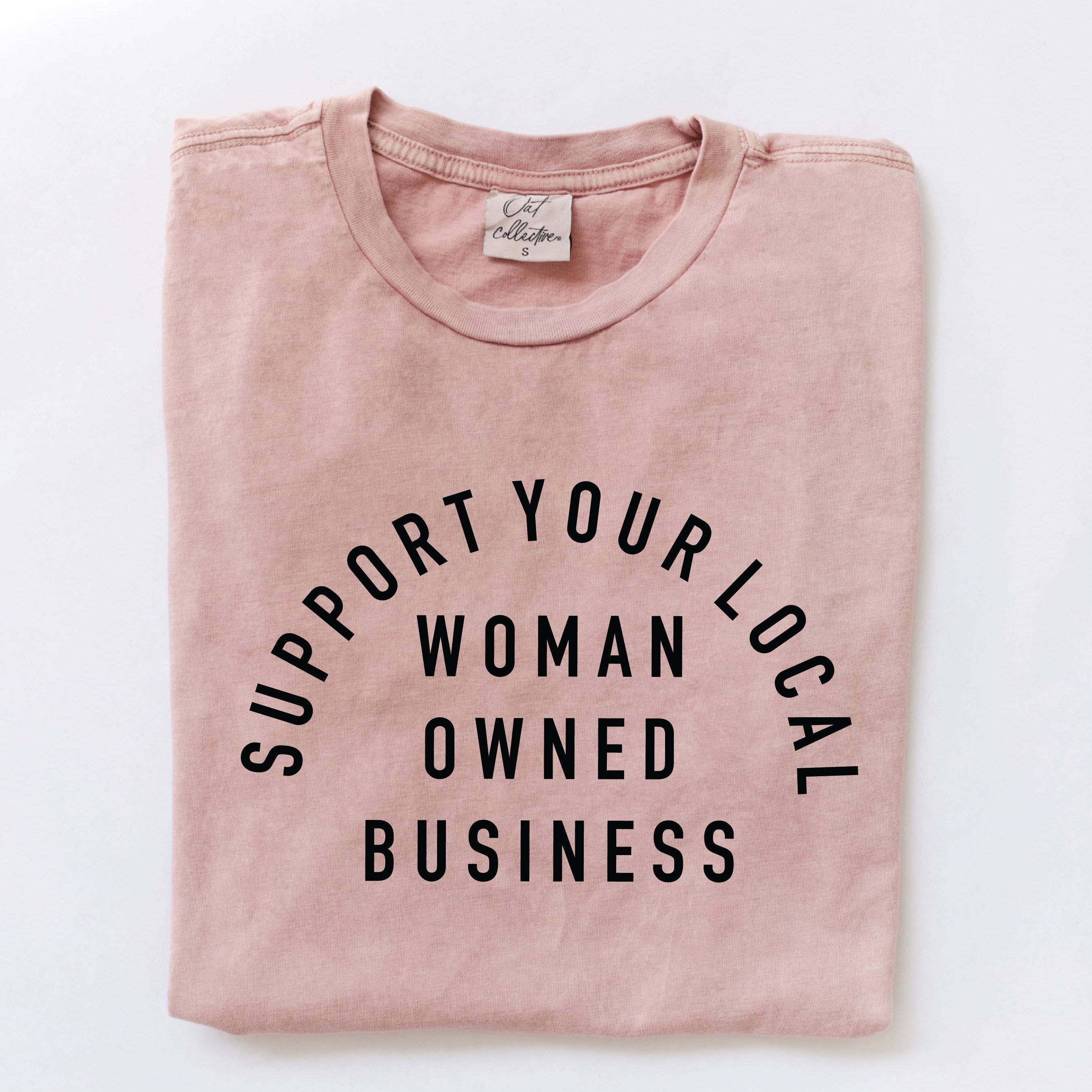 Pink t-shirt with 'Support Your Local Woman Owned Business' text on a white background