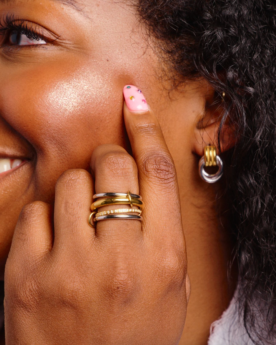 Woman wearing Beautiful mixed metal silver and gold stacked four ring set