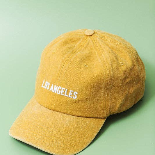 Yellow cap with 'Los Angeles' text on a green background