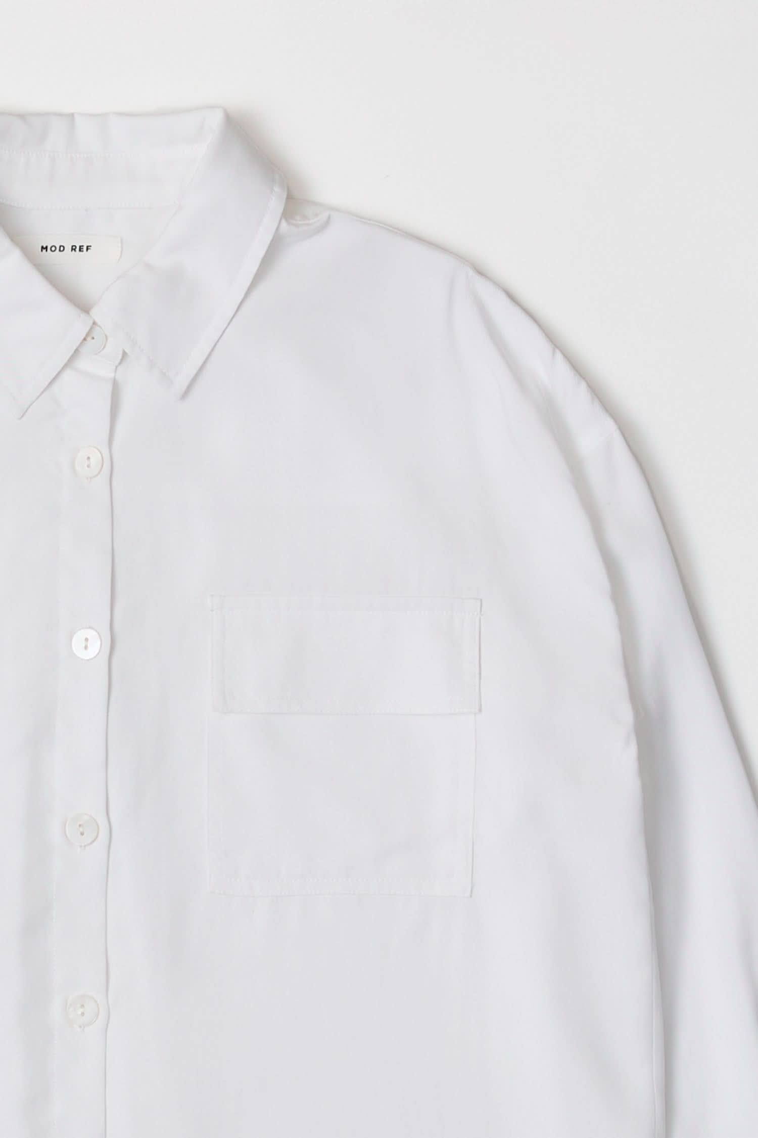 woman wearing white oversized classic button-down shirt