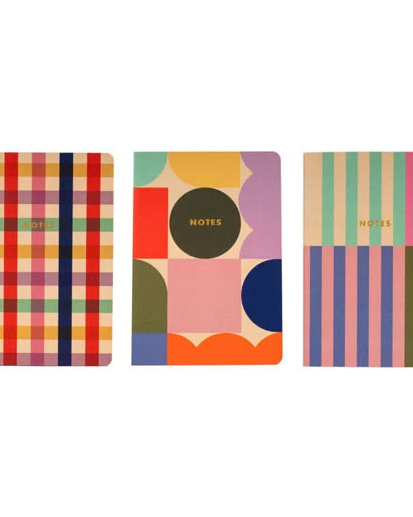 Three notebooks side by side in various prints
