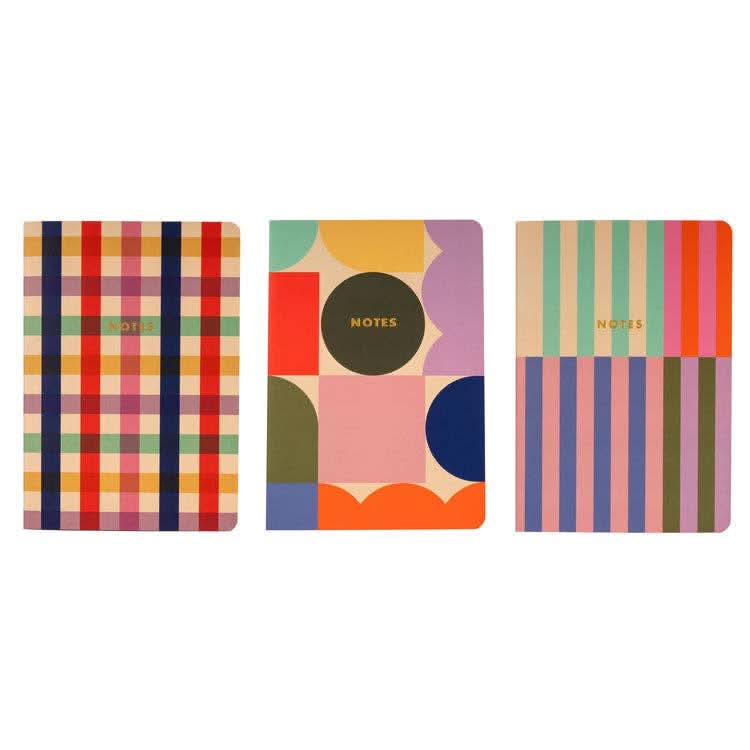 Three notebooks side by side in various prints
