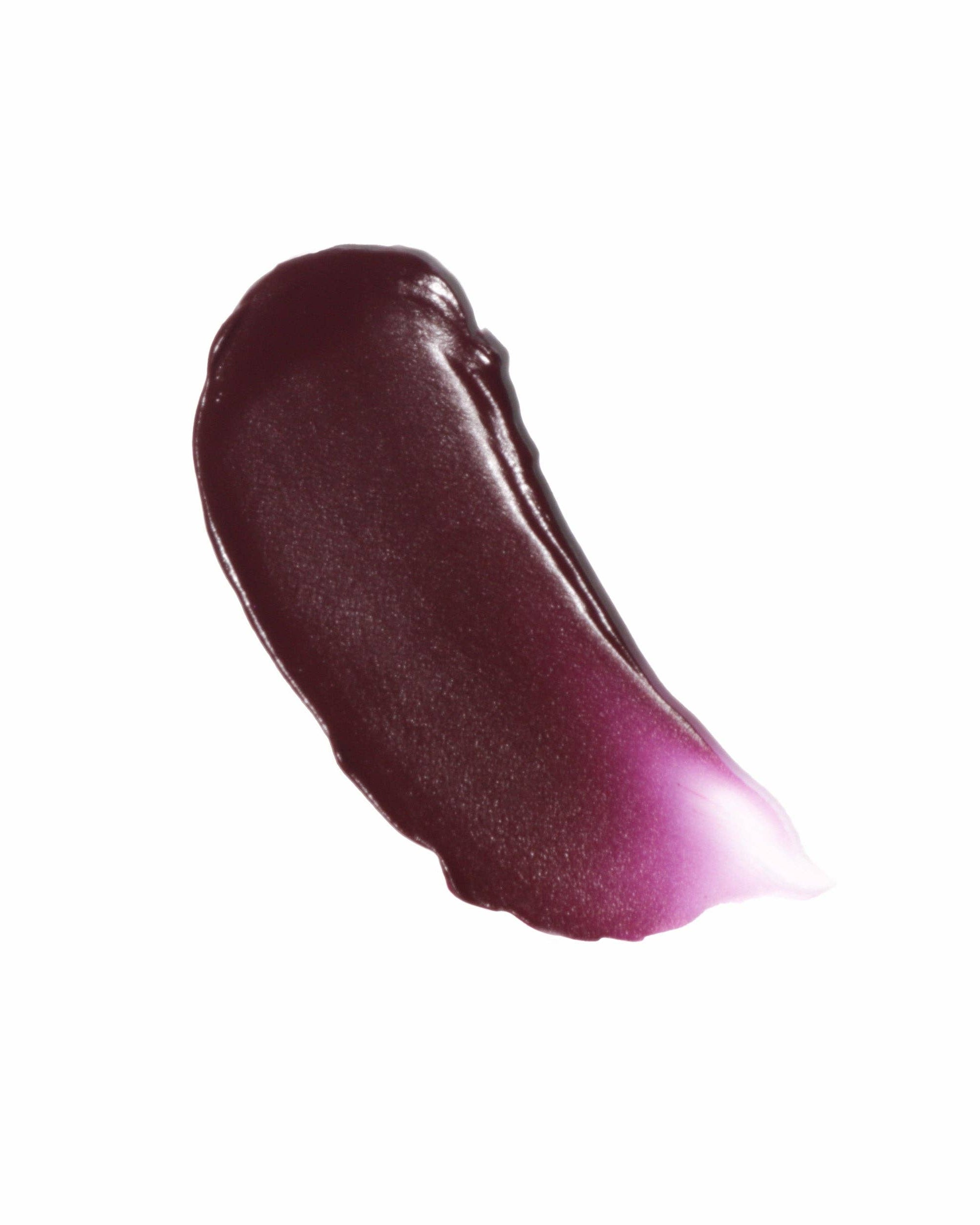 Swatch of dark purple lip gloss on a white background